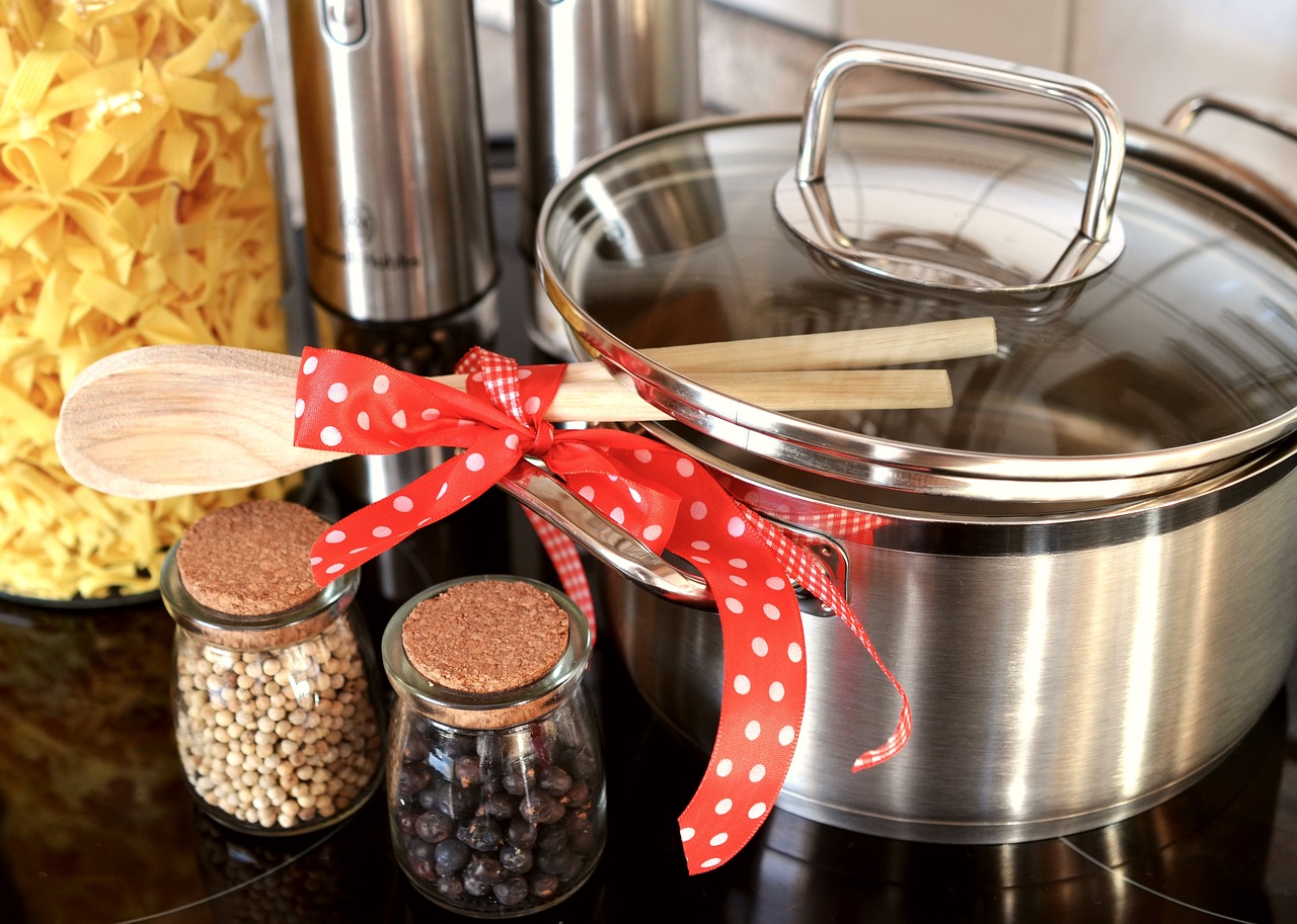 Cooking pot, spices, and wooden cooking spoons 