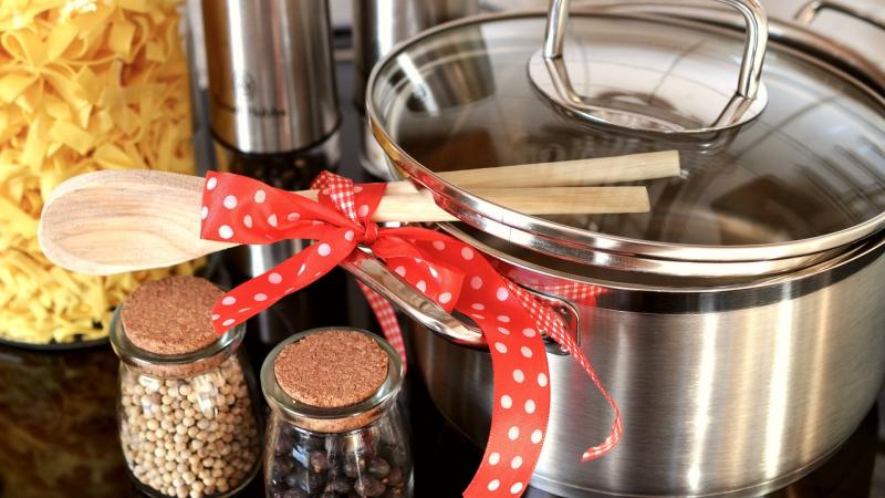 Cooking pot, spices, and wooden cooking spoons 